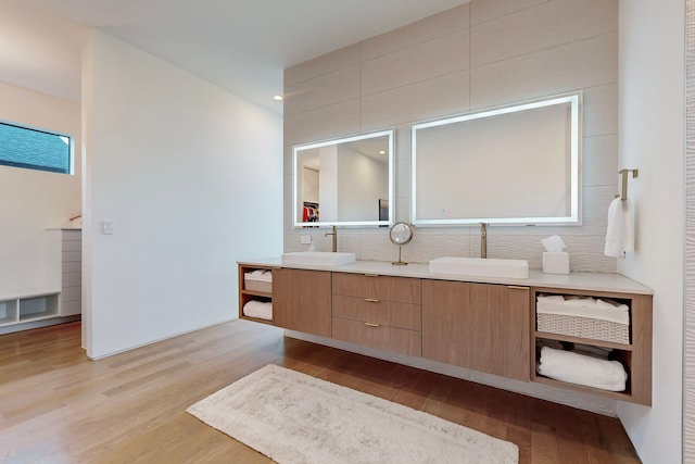 bathroom with vanity, backsplash, and hardwood / wood-style flooring