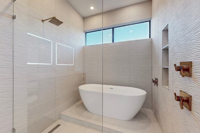 bathroom featuring a shower, tile walls, and tile patterned floors