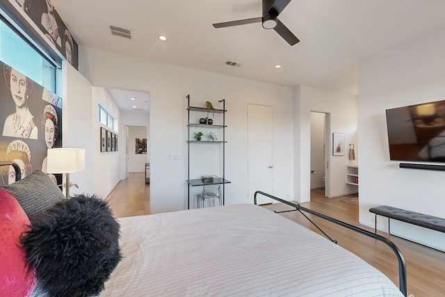 bedroom with ceiling fan and light hardwood / wood-style flooring