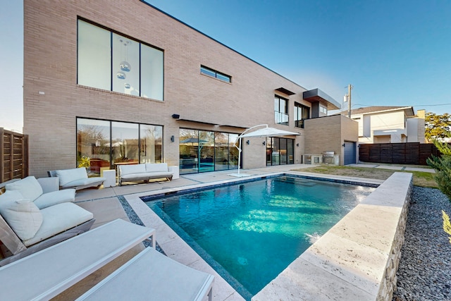 view of swimming pool featuring a grill, an outdoor hangout area, and a patio area