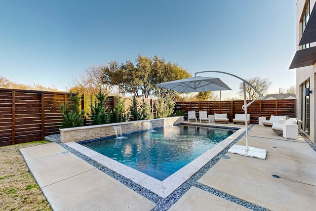 view of pool with pool water feature, an outdoor hangout area, and a patio area