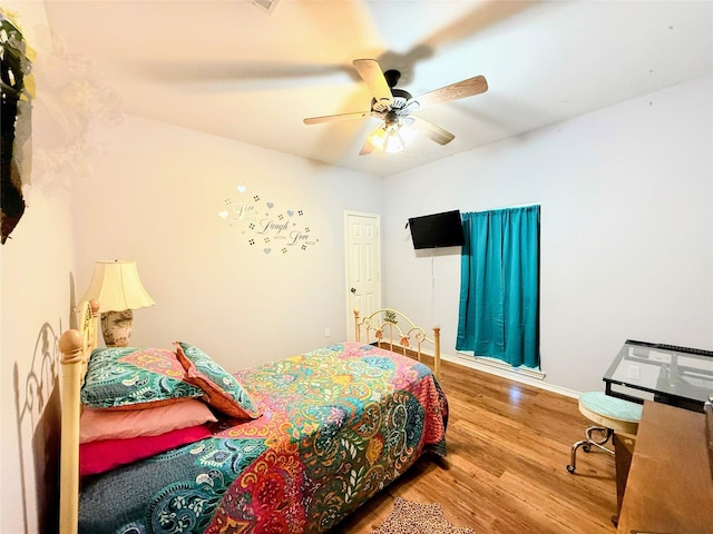 bedroom with ceiling fan and hardwood / wood-style flooring