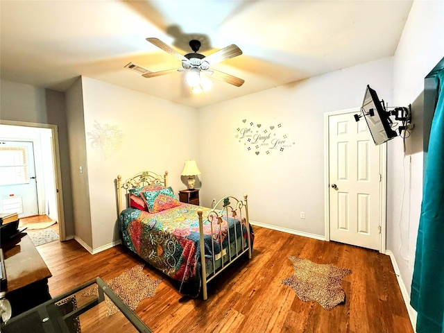 bedroom featuring ceiling fan and dark wood-type flooring