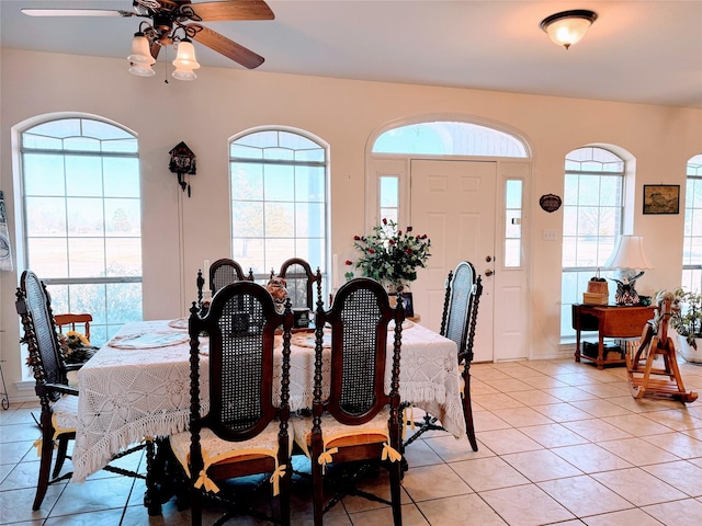 tiled dining area with ceiling fan