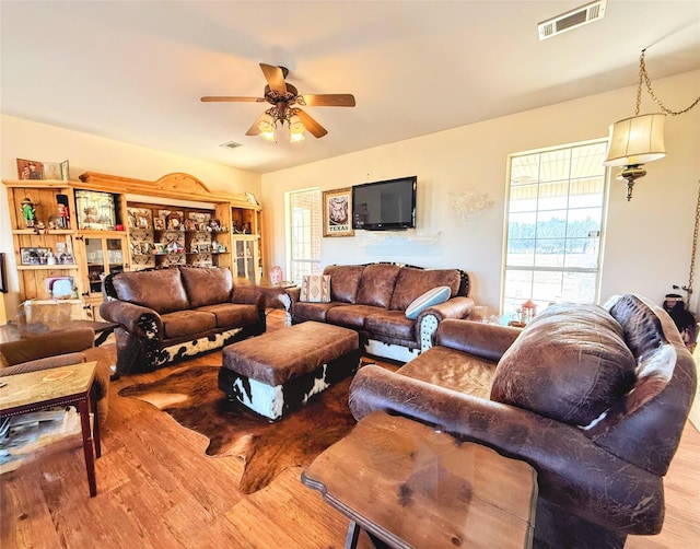 living room with light hardwood / wood-style floors and ceiling fan