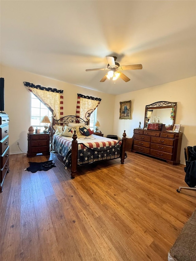 bedroom with ceiling fan and hardwood / wood-style floors