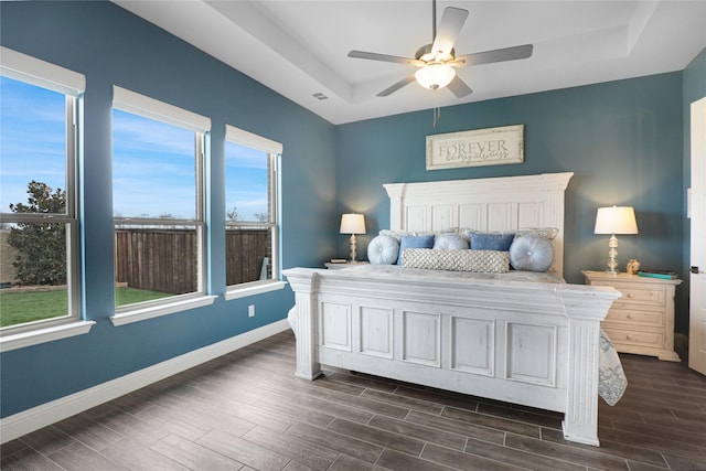 bedroom featuring ceiling fan and a tray ceiling