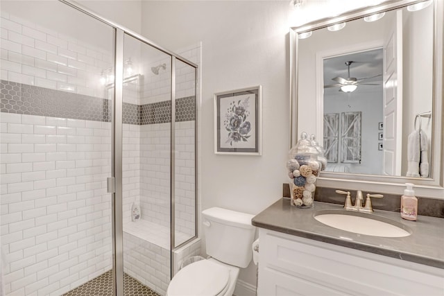 bathroom featuring vanity, an enclosed shower, toilet, and ceiling fan