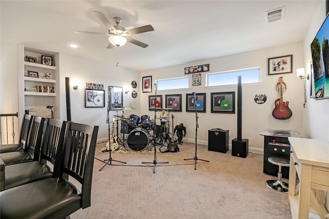 interior space featuring light colored carpet and ceiling fan