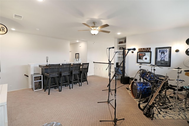 interior space featuring ceiling fan, bar area, beverage cooler, and light carpet