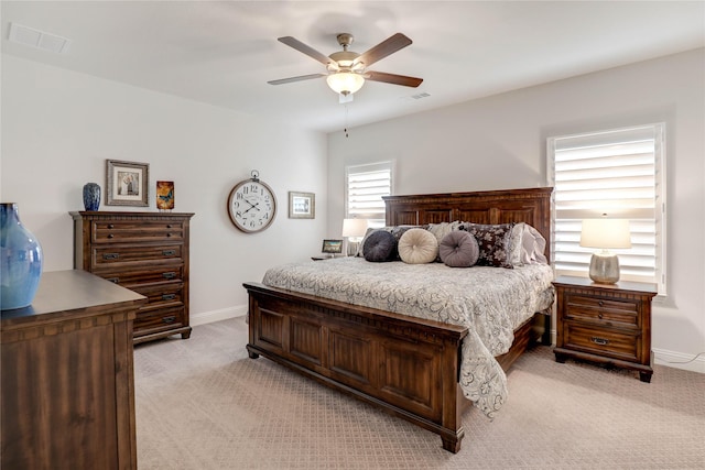 bedroom featuring light carpet and ceiling fan