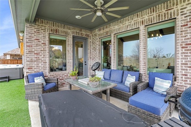 view of patio featuring an outdoor living space, a hot tub, and ceiling fan