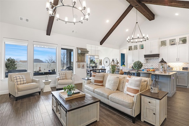 living room with beam ceiling, dark wood-type flooring, high vaulted ceiling, and a chandelier