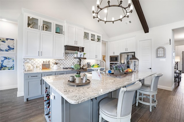 kitchen featuring stainless steel appliances, white cabinets, and a spacious island