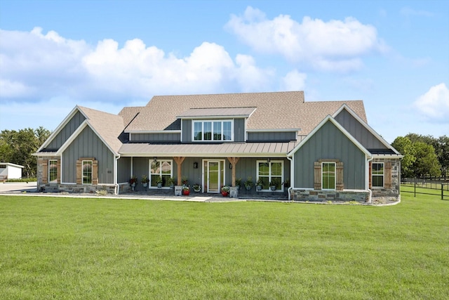 rear view of property featuring a yard