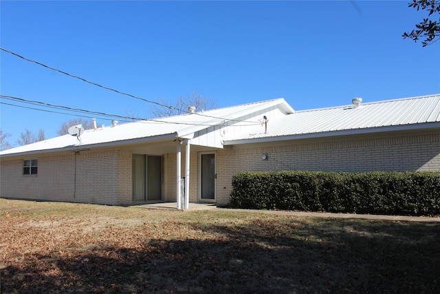 rear view of property featuring a yard