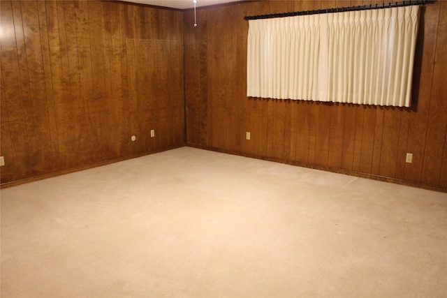 carpeted empty room with wooden walls