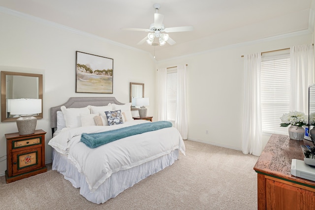 carpeted bedroom with ceiling fan and ornamental molding