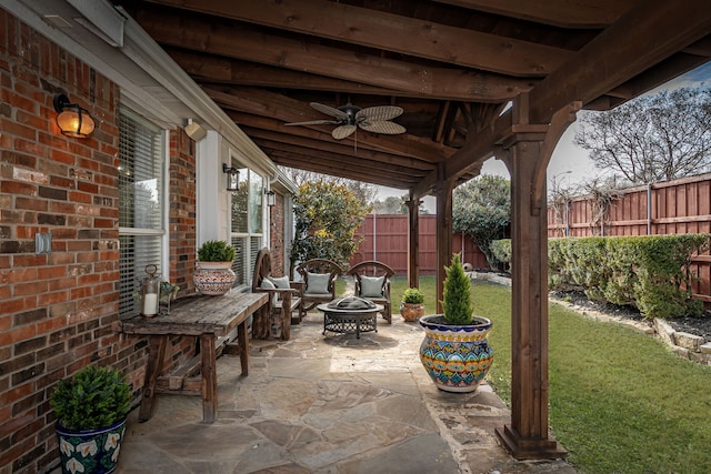 view of patio featuring ceiling fan and an outdoor fire pit