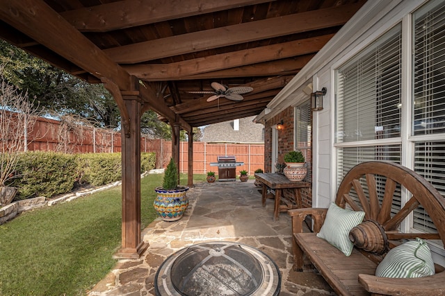 view of patio / terrace featuring a grill, ceiling fan, and a fire pit