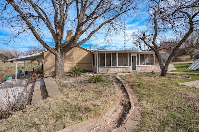 back of property featuring a sunroom