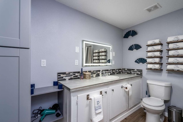 mudroom featuring dark hardwood / wood-style flooring, ceiling fan, a textured ceiling, and brick wall