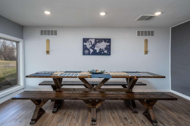 dining space featuring breakfast area and dark wood-type flooring