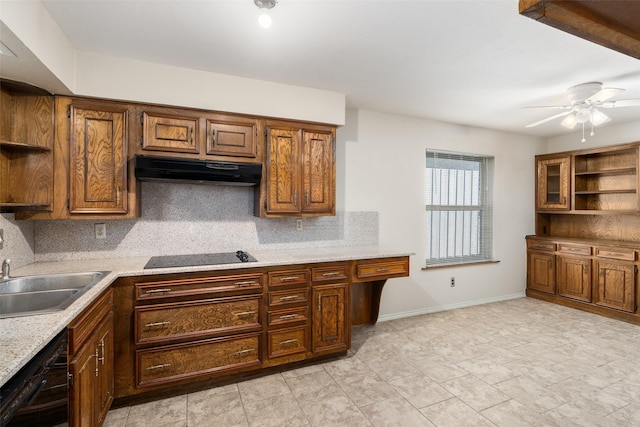 kitchen with ceiling fan, sink, light stone countertops, black appliances, and decorative backsplash