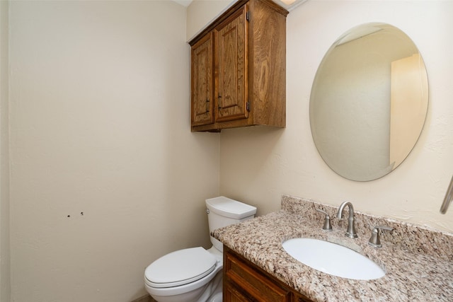 bathroom featuring toilet and vanity