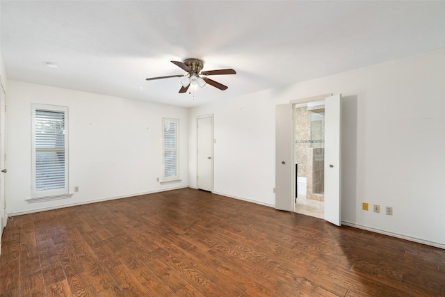 spare room with ceiling fan and dark hardwood / wood-style floors