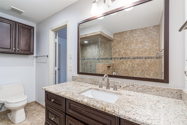 bathroom with toilet, tile patterned flooring, an enclosed shower, and vanity