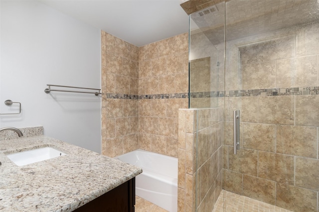 bathroom featuring independent shower and bath and vanity