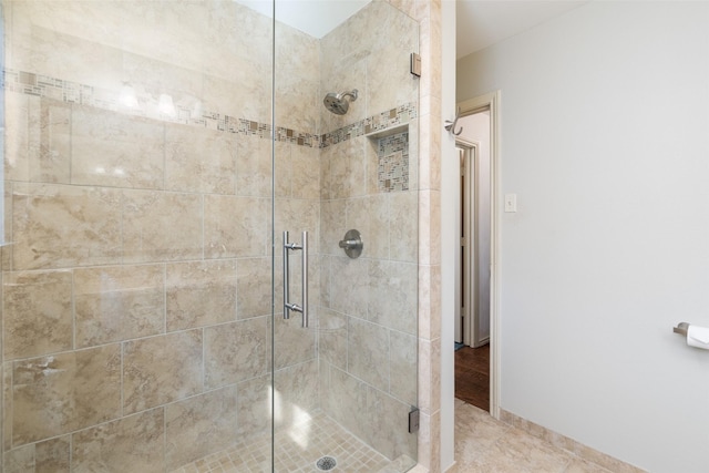 bathroom featuring a shower with shower door