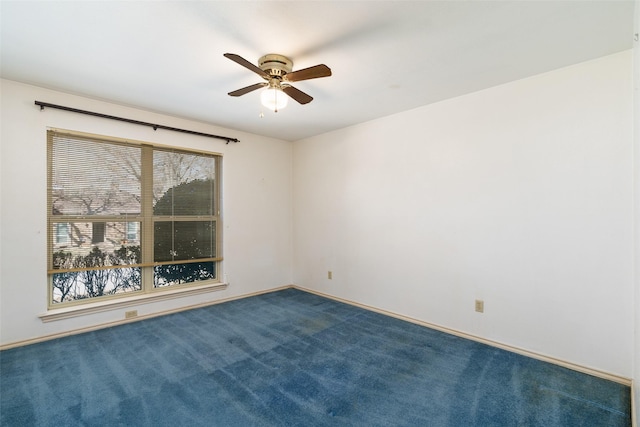 carpeted spare room featuring ceiling fan