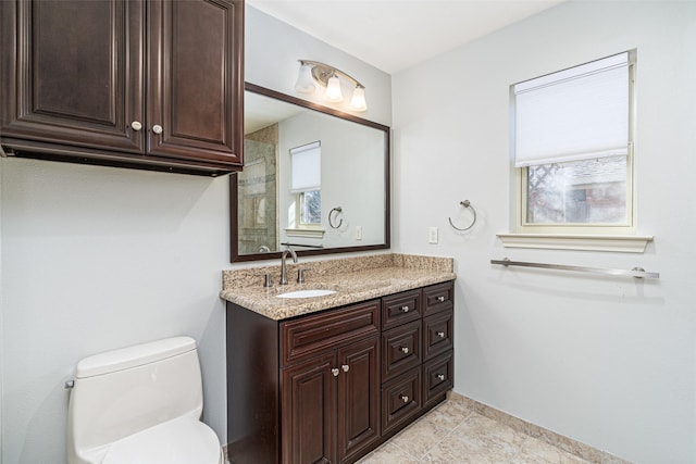 bathroom featuring toilet and vanity