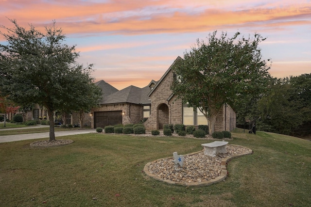 view of front of house with a garage and a lawn