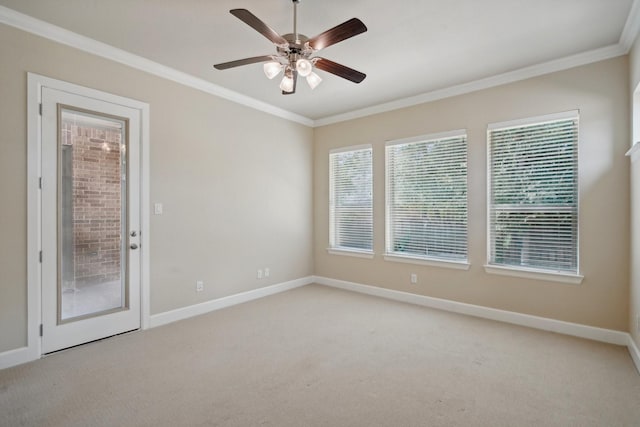 carpeted empty room with ceiling fan and crown molding