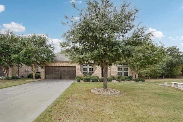 view of front of property featuring a garage and a front yard