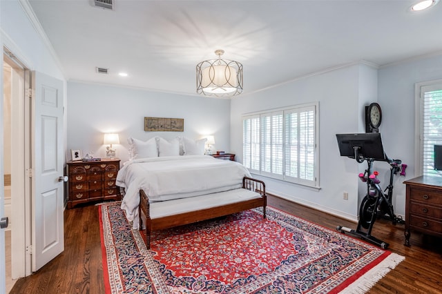 bedroom featuring ornamental molding and dark wood-type flooring