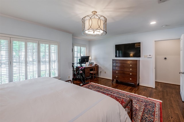 bedroom with crown molding and dark hardwood / wood-style floors