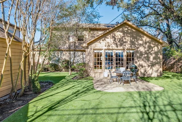 rear view of property featuring a yard and a patio