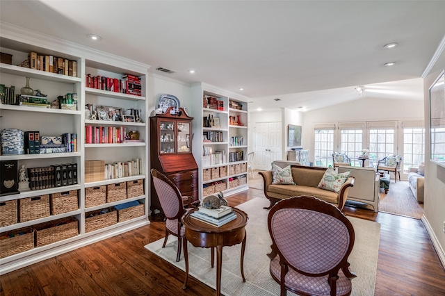 interior space with wood-type flooring, lofted ceiling, and crown molding