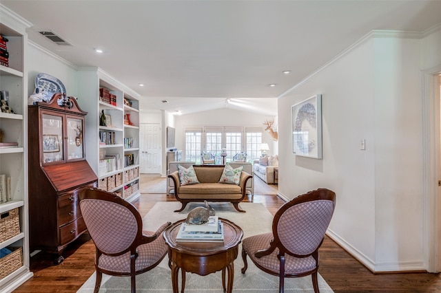 sitting room with crown molding, hardwood / wood-style flooring, and built in shelves