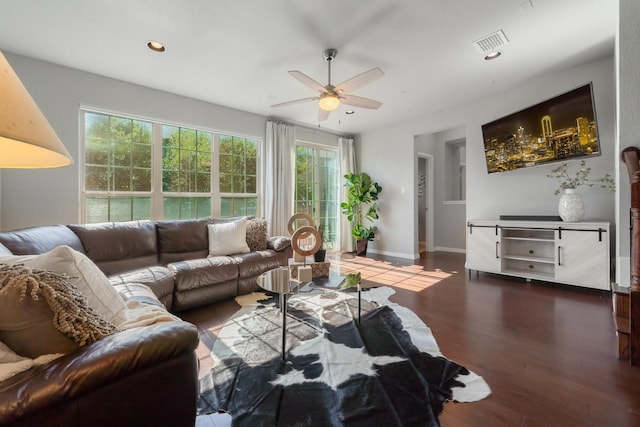 living room with ceiling fan, dark hardwood / wood-style flooring, and a healthy amount of sunlight