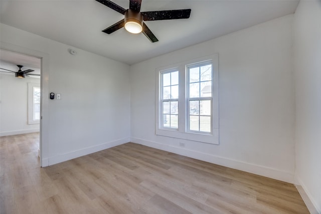 empty room with ceiling fan and light hardwood / wood-style flooring