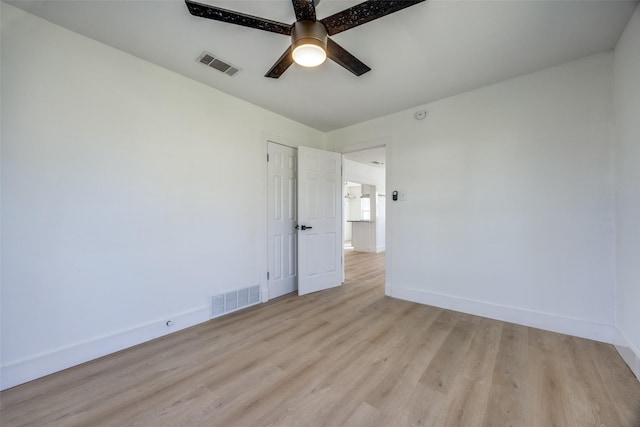 empty room with ceiling fan and light hardwood / wood-style flooring