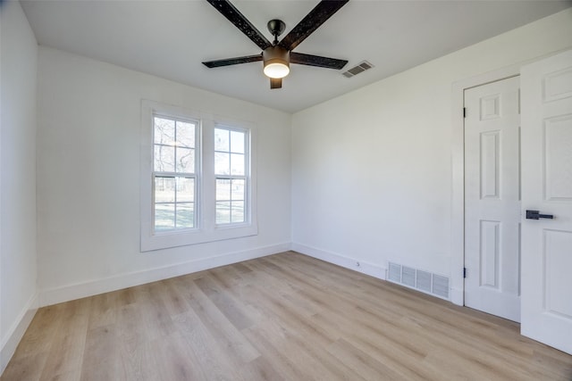 empty room with ceiling fan and light hardwood / wood-style flooring