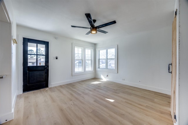 foyer entrance with light hardwood / wood-style floors, ceiling fan, and a healthy amount of sunlight