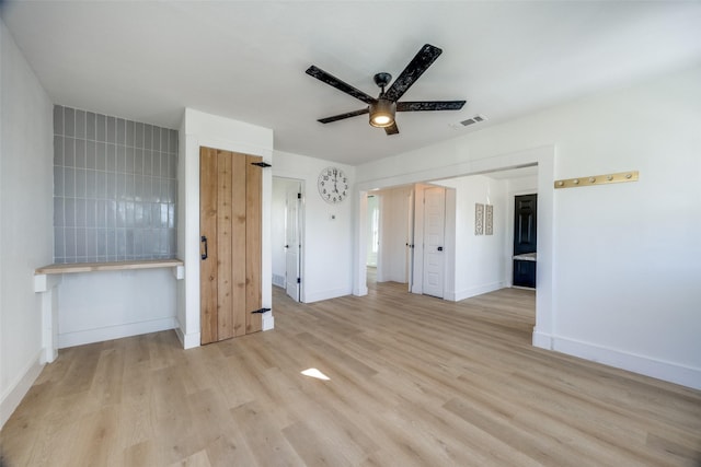 unfurnished bedroom featuring ceiling fan and light hardwood / wood-style floors