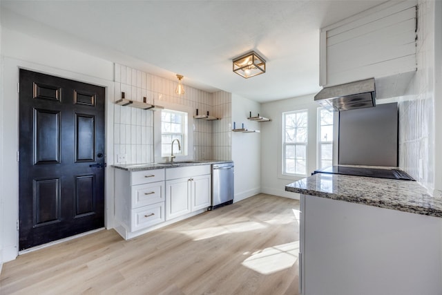 kitchen featuring dishwasher, sink, white cabinets, light wood-type flooring, and light stone counters